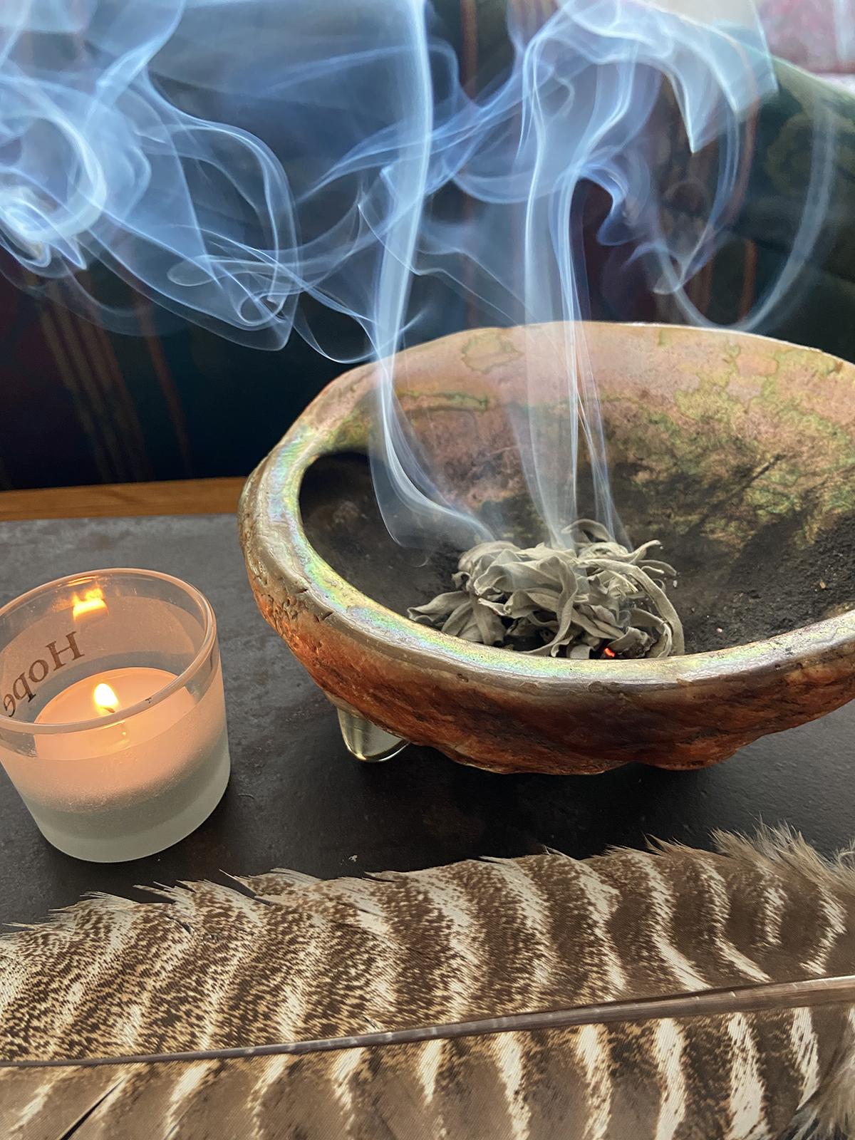 sage smudge in bowl with feather