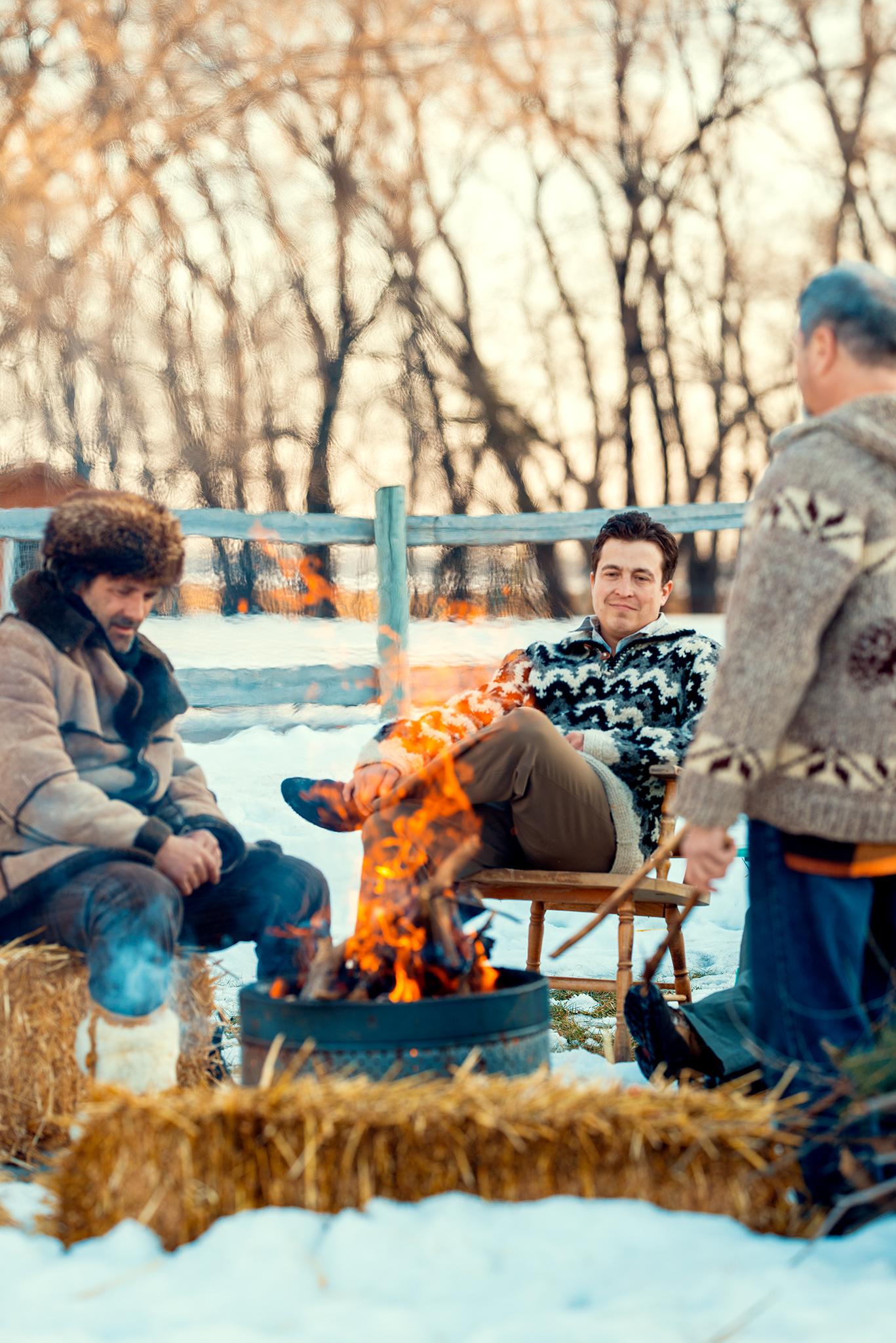 3 men enjoying a fire at Moon Gate in the winter