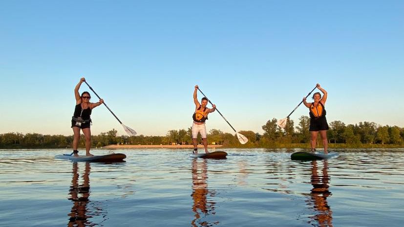 3 women paddling on SUP boards with Nature's Edge Tourism.