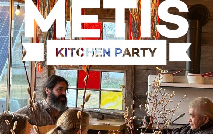 Métis Kitchen Party Banner with sash and lights hanging in the background.