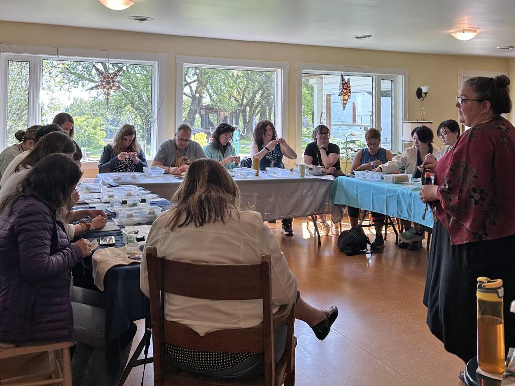 ladies enjoying a workshop lead by Melanie from Borealis Beading.
