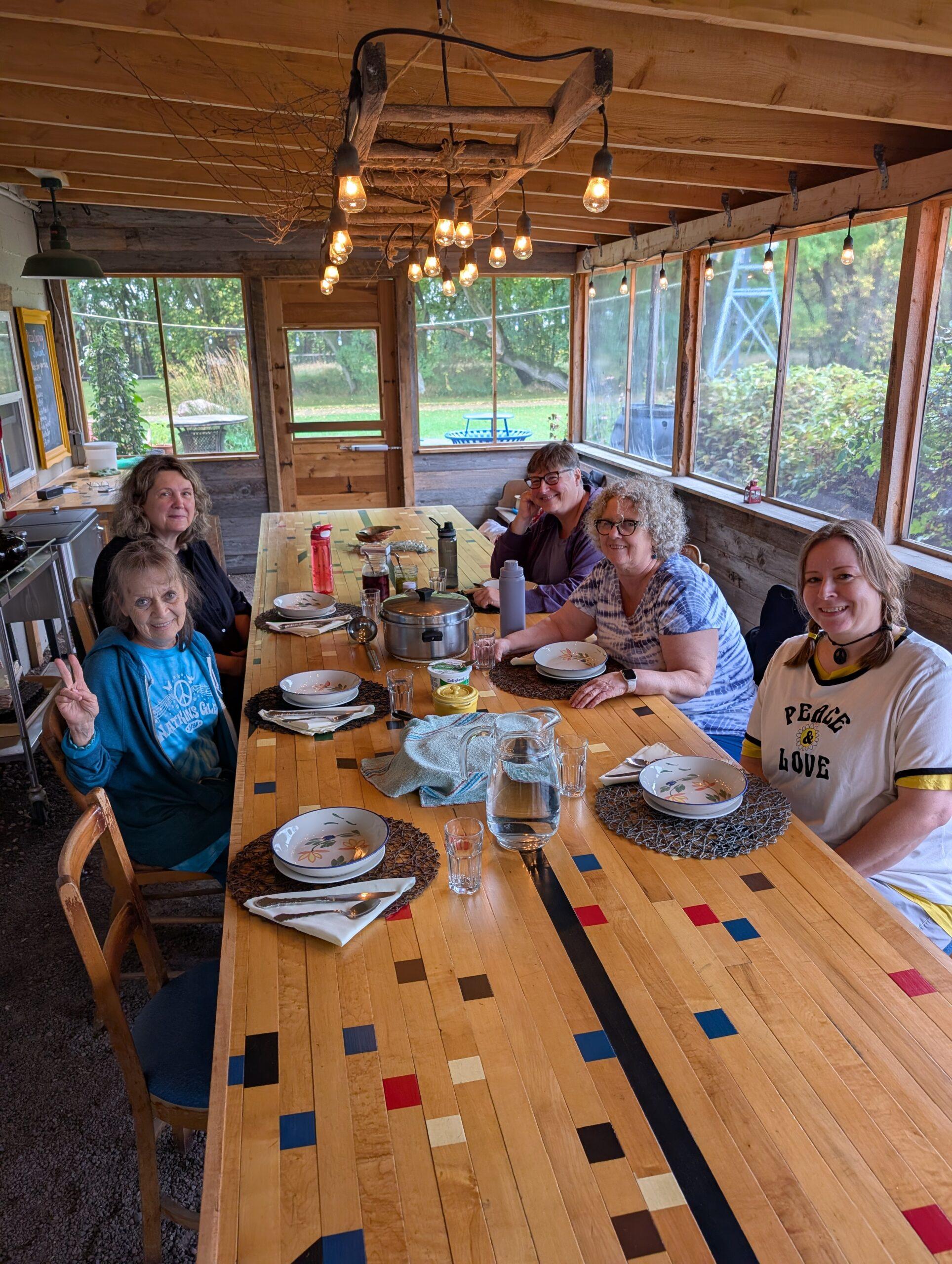 Daytrippers Peace Day event with 5 women sitting around the table.